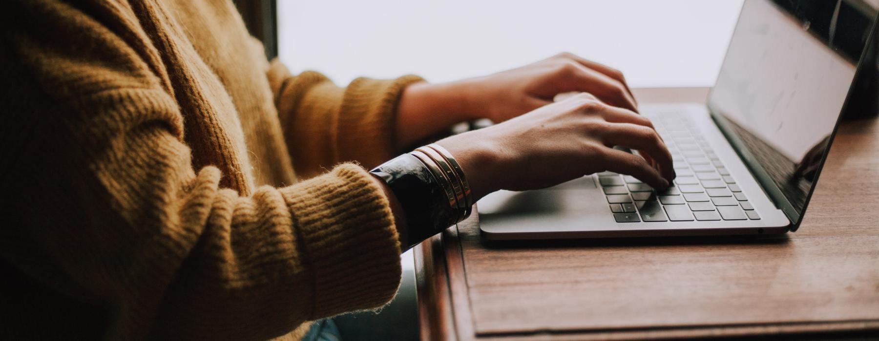 a person typing on a laptop