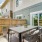fenced-in patio with a plant and a table